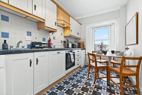 Bright and fully equipped kitchen with dining table
