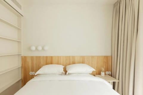 Unwind in crisp linens beneath warm wood accents.