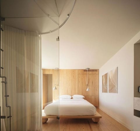 Drift off in a serene bedroom with warm wood accents.