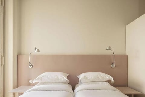 Drift off beneath soft lighting and plush, perfectly stacked pillows.