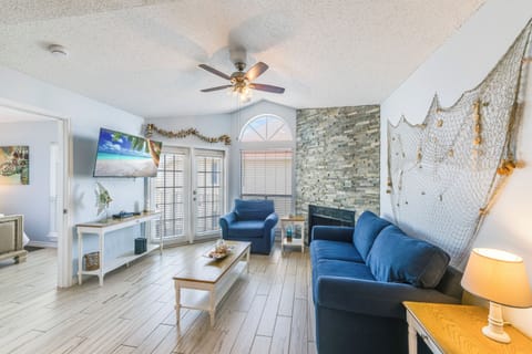 Relax in your coastal-themed living space with cozy blue seating, nautical decor, and a fireplace for perfect evenings in.