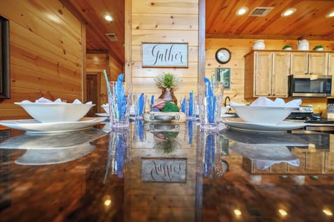 You'll love gathering around this stunning granite island with elegant blue glassware and rustic charm throughout your cabin retreat.