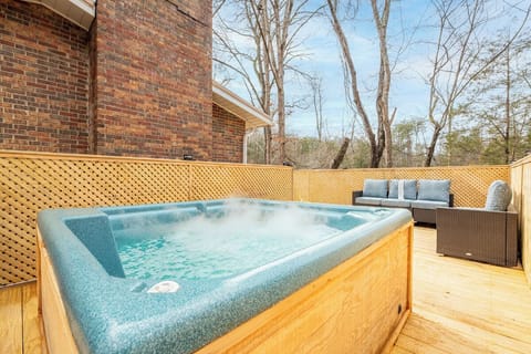 Soak in your bubbling hot tub on the secluded deck, surrounded by comfortable outdoor seating.