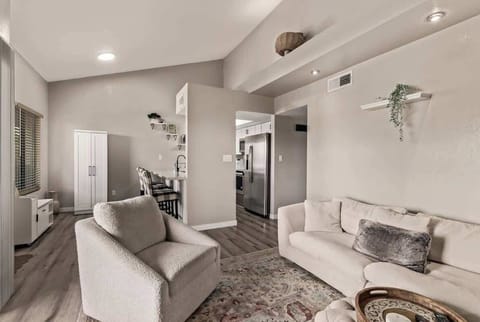 Relax in the spacious living room featuring cozy seating, smart TV, and natural light — perfect for unwinding after a long day.