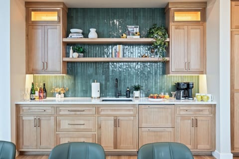 Wet bar adjacent to the dining table with 12-cup drip coffee maker (coffee beans provided), coffee grinder, frother, and 2 pull-out refrigerator drawers