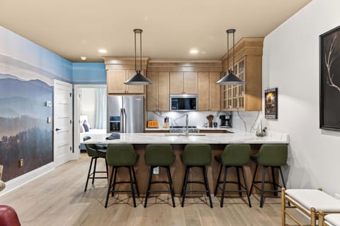 Fully equipped kitchen with a roomy island—grab a seat at the breakfast bar and keep the conversation going.