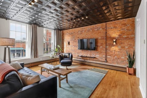 Living Room:  Massive window overlooking Main St.  Bright sunny afternoons!  Comfortable and stylish sofa and arm chair.