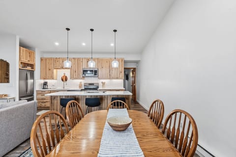 Gather around this spacious dining table where your family meals become cherished memories, perfectly connected to the modern kitchen.