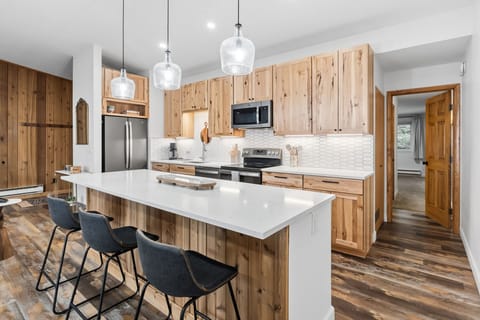 Your spacious kitchen features warm wood cabinets, gleaming countertops, and a large island perfect for morning coffee or evening gatherings.