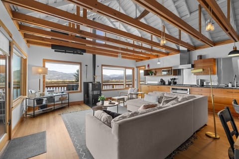 Relax in your open-concept living space with soaring wood beams, mountain views, and everything you need to unwind.