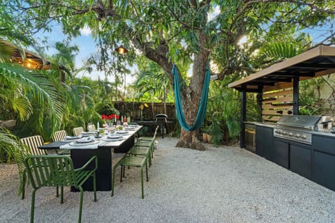 Enjoy meals al fresco in a beautiful garden setting with a hammock, ambient lighting, pizza oven, grill  and plenty of space for family and friends