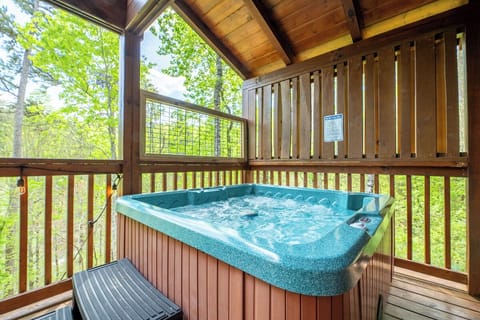 Soak your worries away in your private hot tub, surrounded by lush forest views from this peaceful covered deck.