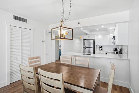 Gather around your spacious dining table beneath elegant lantern lighting, with a modern kitchen just steps away for convenient meal prep.