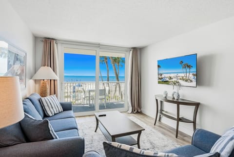 Relax in your bright living room with stunning ocean views through sliding doors to your private balcony.