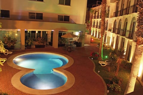Slip into an evening swim under warm courtyard lights.