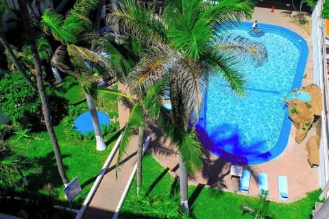 Soak up sunshine beside the sparkling palm-lined resort pool.