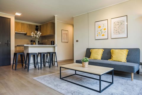 Cozy and stylish living area with a modern kitchen, perfect for relaxing or entertaining guests.