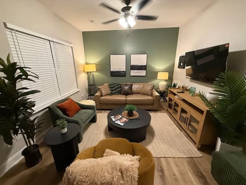 The living room offers ample seating, a 55” Smart TV, and a quiet environment ideal for relaxing after exploring the area.