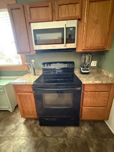 The kitchen is fully stocked with appliances, utensils, cookware, and a dining area suitable for families or longer stays.