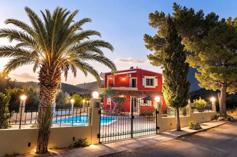 Stunning villa exterior at night with a glowing pool, perfect for evening relaxation