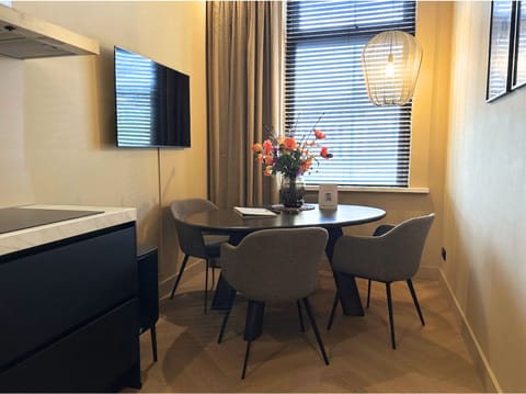 Stylish dining area with modern decor, comfortable seating, and large windows creating a bright and cozy atmosphere.
