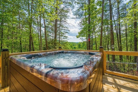 Soak in bubbling bliss while surrounded by towering trees and peaceful forest views from your private deck retreat.