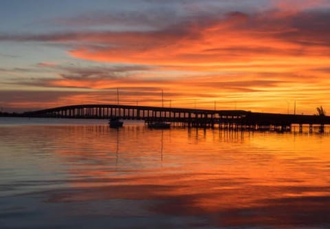 Marvel at the stunning sunset reflecting off the calm water, a perfect ending to your day.