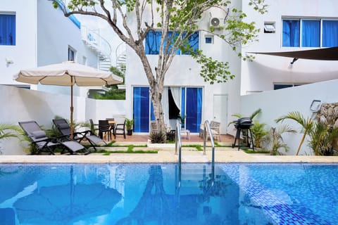 Relax by the private pool with comfortable sun loungers and umbrella — perfect f