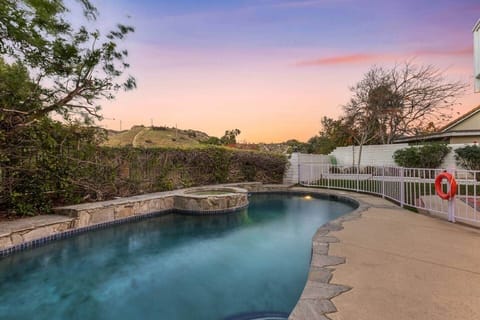 Soak in the hot tub with stunning sunset views over the hills.