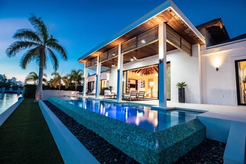 Your private oasis — infinity pool, covered lanai, and canal view