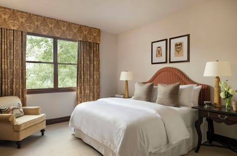 Relax in a bright bedroom with inviting pillows and calm tones.