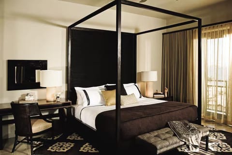 Unwind in a stylish canopy bed after beach adventures
