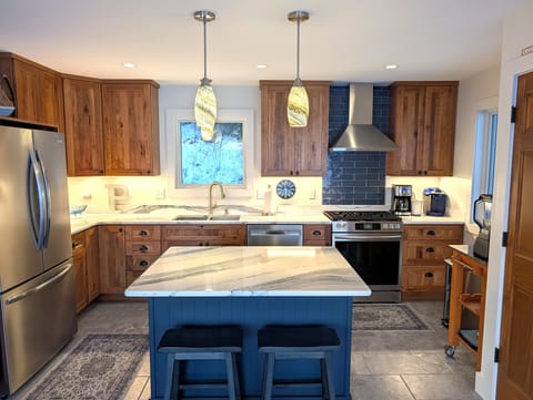 OVERVIEW:  The home has a new and modern kitchen on the main floor with all appliances including a dishwasher.  Also includes a coffee bar, kitchen island, and bar stools.