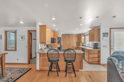 Your spacious kitchen features warm wood cabinets, granite countertops, and a breakfast bar where you can enjoy morning coffee together.