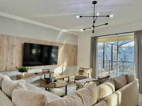 Sink into plush sectional seating while enjoying your favorite shows on the large screen TV in this bright, modern living space.