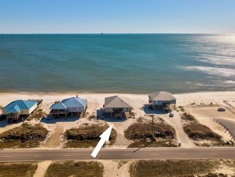 Aerial view showing Sea Turtle beachfront rental property along a pristine coastline with direct access to sandy shores and Gulf waters.