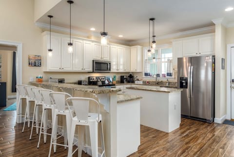 Your spacious kitchen invites culinary adventures with granite counters, modern appliances, and stylish pendant lighting creating the perfect cooking retreat.