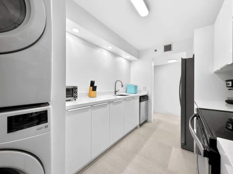 Fully stocked kitchen with modern appliances and essential cookware