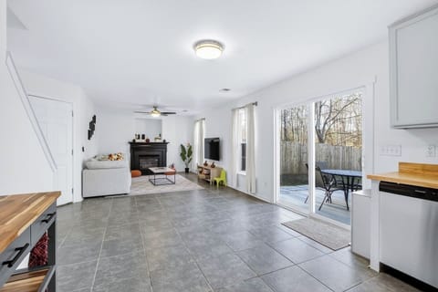 Bright open-concept space connecting the kitchen, dining, and living room.