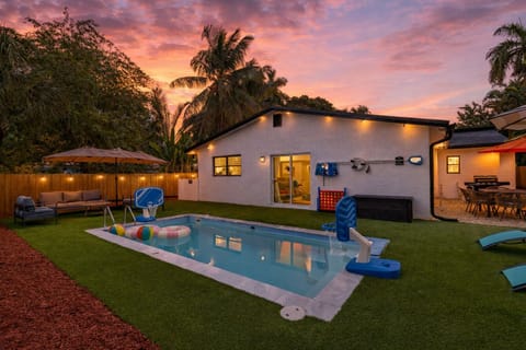 Resort-style backyard with a private pool, turf lounge space, and fun extras for all ages.