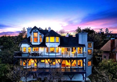 Dusk view of the multi-level mountain estate nestled in the trees.