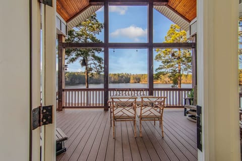Spacious screened lakefront patio with seating area and beautiful views, accessible directly from the living room.
