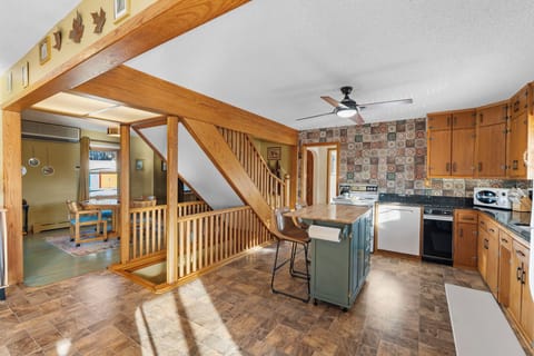 Warm wooden beams and rustic charm create your perfect cooking space, where morning coffee and family meals become cherished memories.