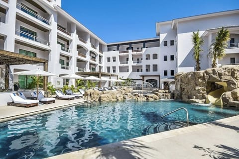 Slip into crystal-clear water beside dramatic rock waterfall features.
