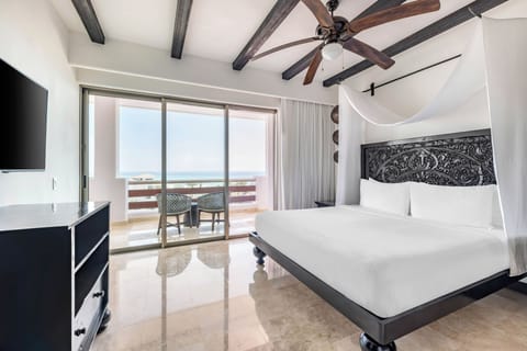 Savor ocean breezes from bed with a private balcony view.