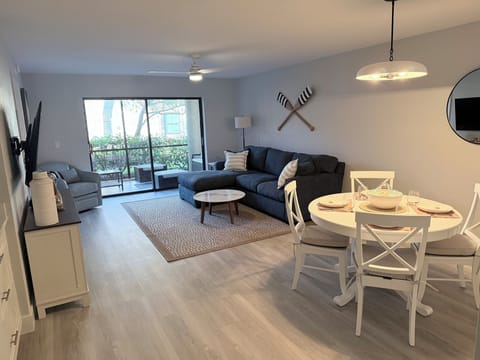 Overview of the dining and living space looking out over the screened-in lanai.