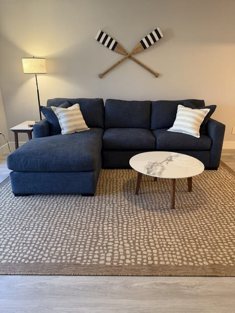Large, comfy sectional couch in nautical navy, and two coffee tables