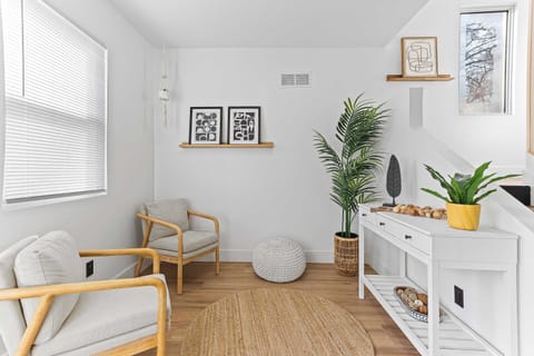 Charming living space with natural light, warm wood floors, and modern décor accents. A comfortable area perfect for relaxing, reading, or enjoying quiet moments during your stay.