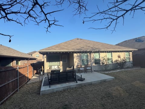 Private back patio with a BBQ grill and fire pit.