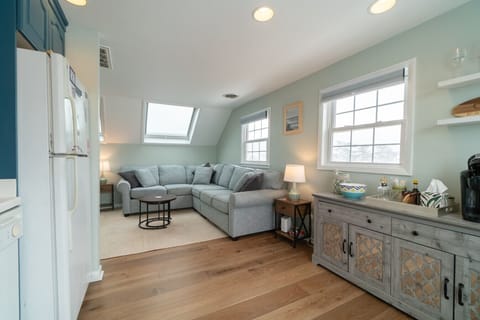 Bright and comfortable living area with a spacious L-shaped sofa — perfect for movie nights or relaxing after a beach day.